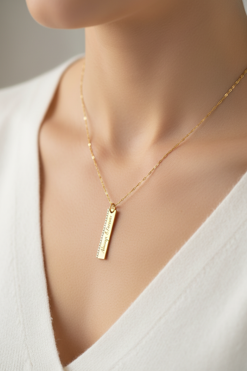 Close-up of engraved pendant necklace being worn