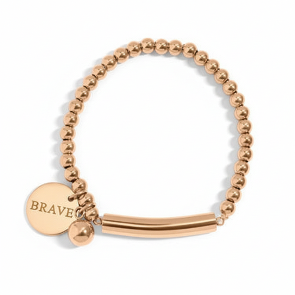 Gold beaded bracelet with BRAVE engraving