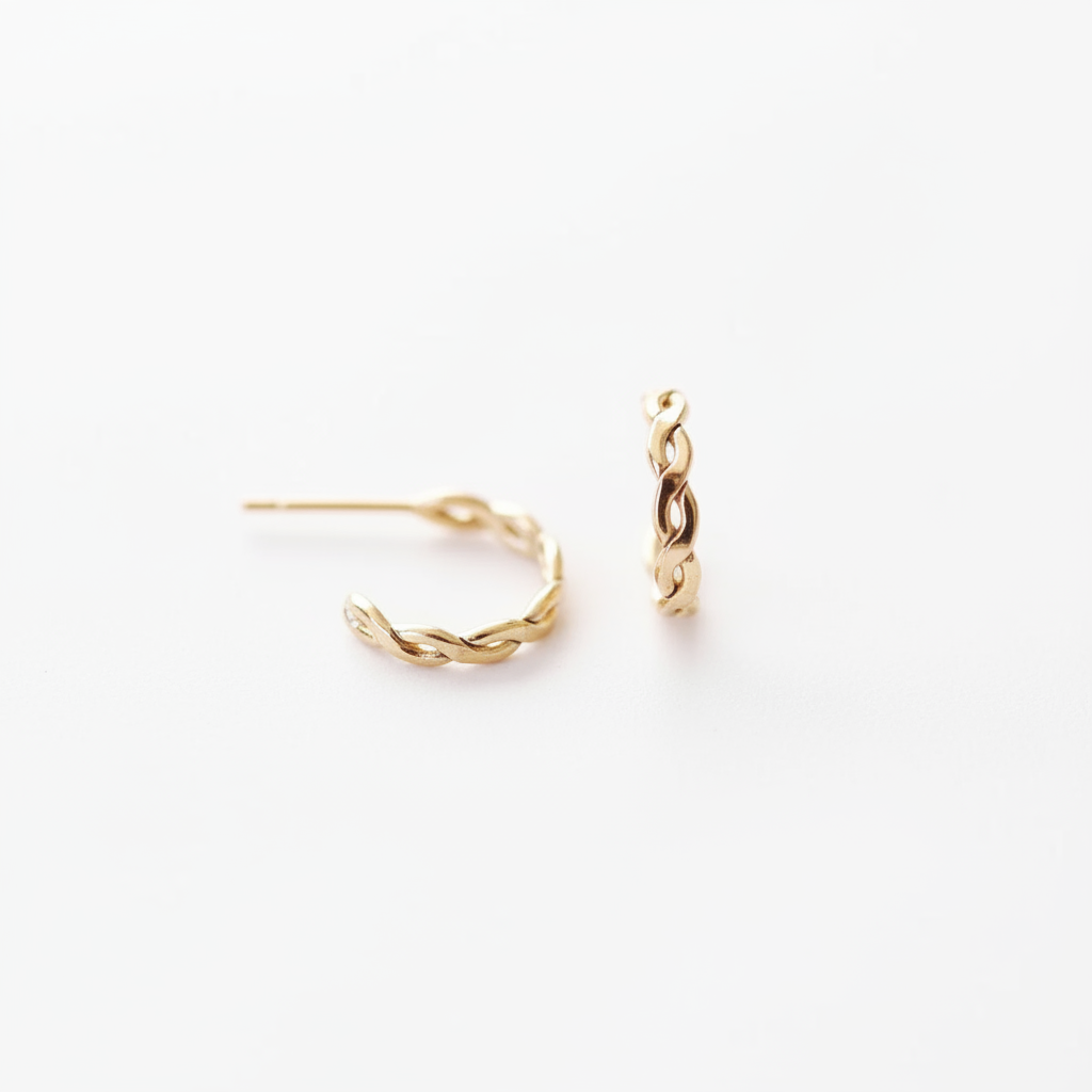 Gold chain hoop earrings on white background