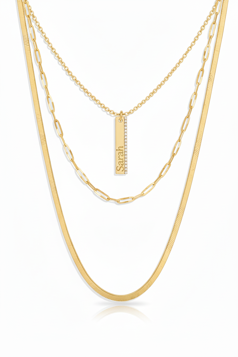 Layered gold necklace with Sarah engraved vertically